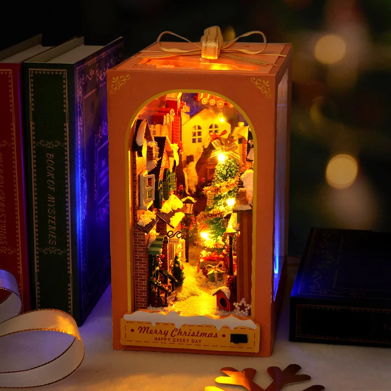 Snowy lit village street inside the gift-box facade